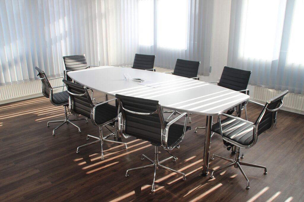 An empty meeting room table set up for a group discussion