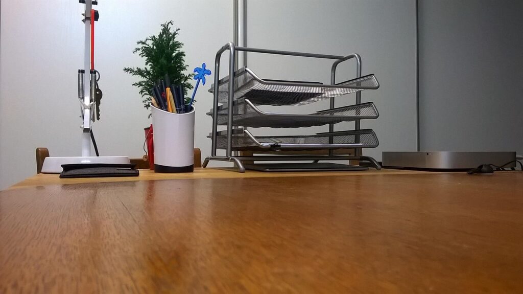 Empty paper trays and a pen pot on an office desk